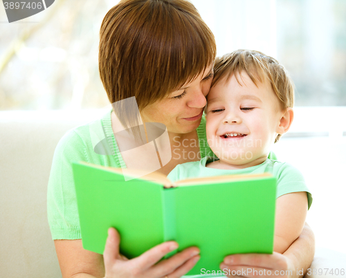 Image of Mother is reading book for her son