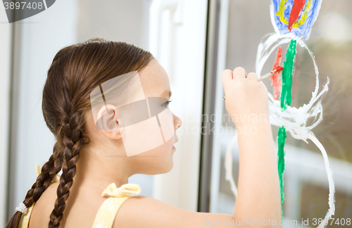 Image of Portrait of a cute girl playing with paints
