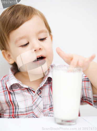 Image of Cute little boy with a glass of milk