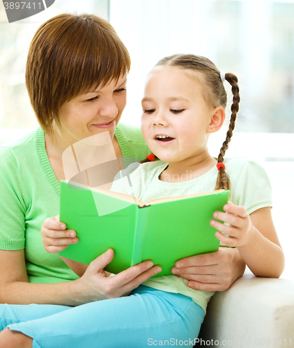 Image of Mother is reading book with her daughter