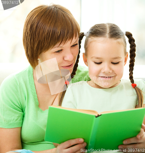 Image of Mother is reading book with her daughter