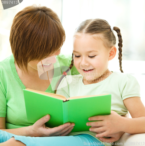 Image of Mother is reading book with her daughter