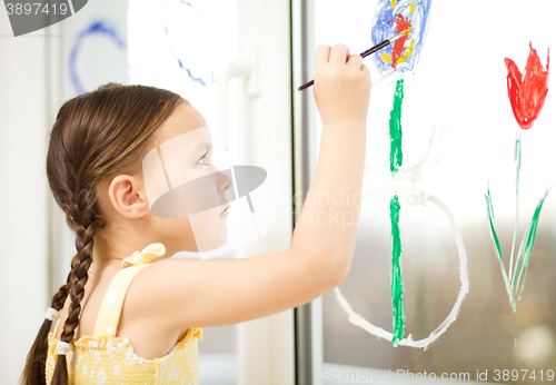 Image of Portrait of a cute girl playing with paints