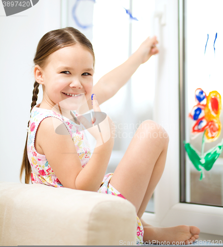 Image of Portrait of a cute girl playing with paints