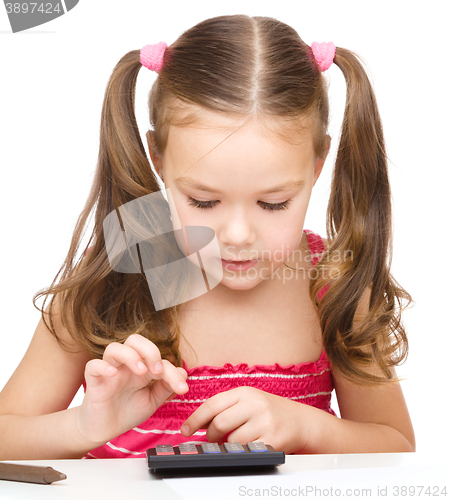 Image of Little girl is using calculator