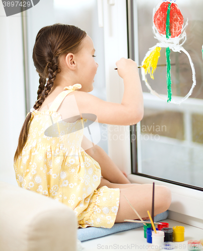 Image of Portrait of a cute girl playing with paints