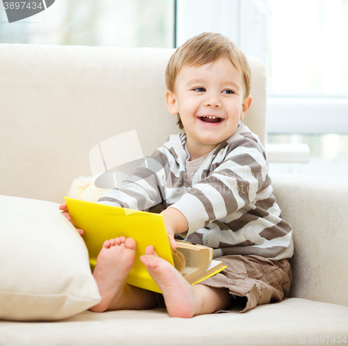 Image of Little boy is reading book