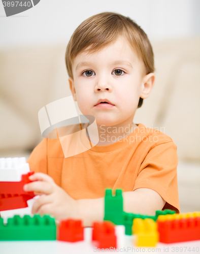 Image of Boy is playing with building blocks