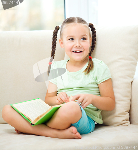 Image of Little girl reads a book