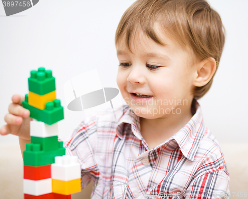 Image of Boy is playing with building blocks