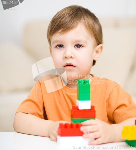 Image of Boy is playing with building blocks