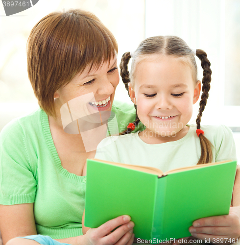 Image of Mother is reading book for her daughter