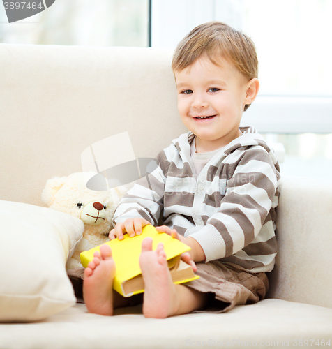 Image of Little boy is reading book