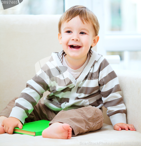 Image of Little boy is reading book