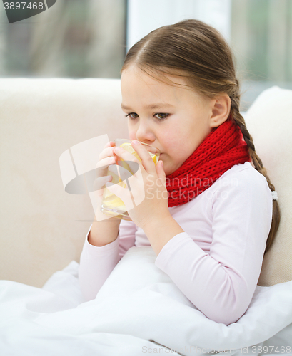 Image of Ill little girl is drinking vitamin cocktail