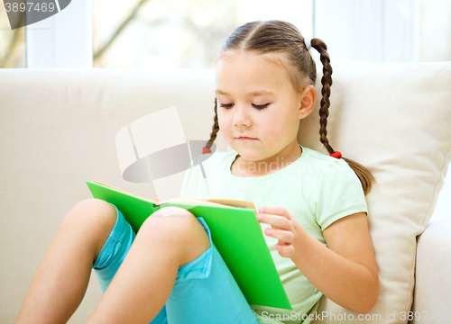 Image of Little girl reads a book