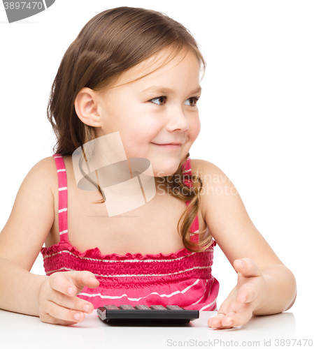 Image of Little girl is using calculator