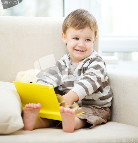 Image of Little boy is reading book