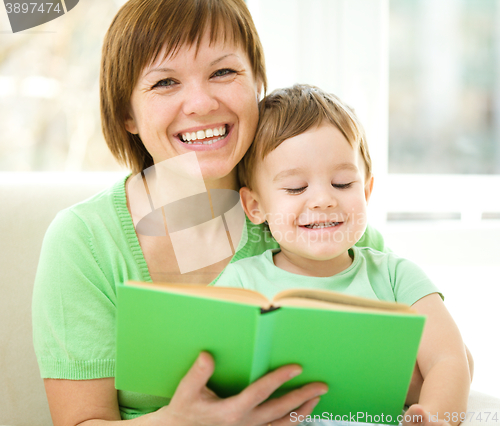 Image of Mother is reading book for her son