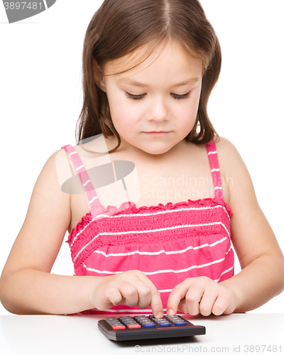 Image of Little girl is using calculator