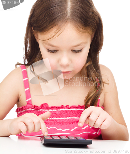 Image of Little girl is using calculator