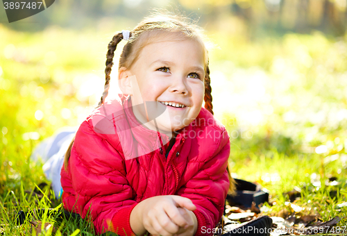 Image of Portrait of a little girl in autumn park