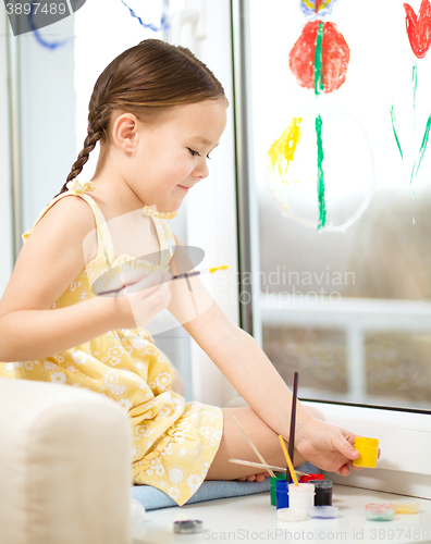 Image of Portrait of a cute girl playing with paints