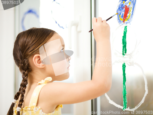 Image of Portrait of a cute girl playing with paints