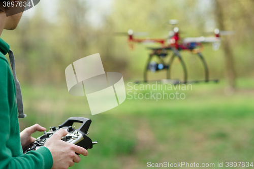 Image of Man controling a drone.