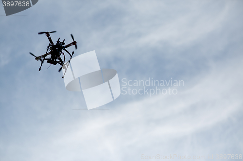 Image of flying drone with camera on the sky