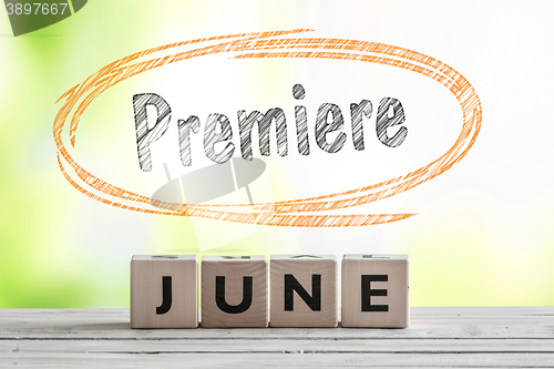 Image of June premiere sign on a wooden stage