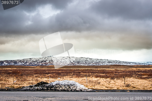 Image of Snow by a road in dramatic scenery