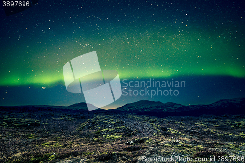 Image of Aurora Borealis over distant mountains