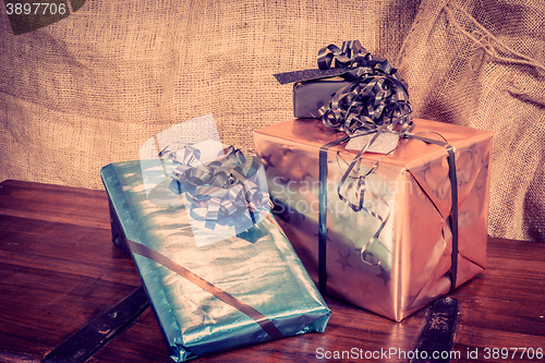 Image of Shiny gift boxes on a wooden table