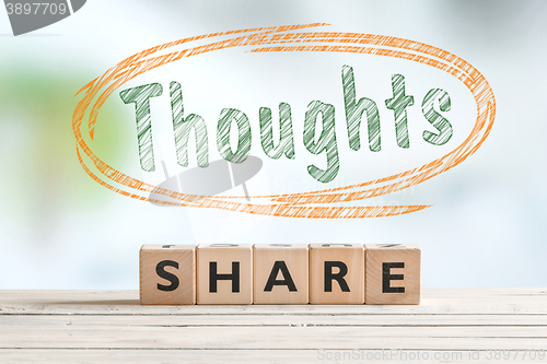 Image of Share your thoughts sign on a desk