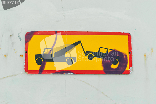 Image of Sign of a truck removing a car