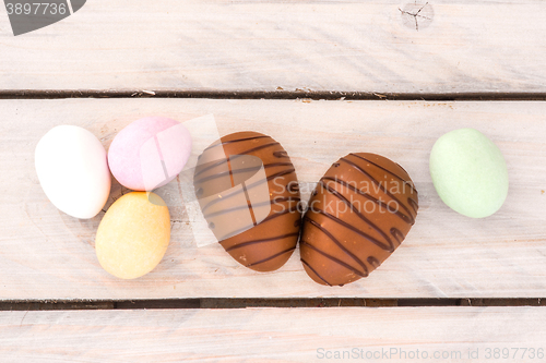 Image of Easter candy eggs on a wooden table