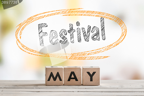 Image of May festival sign on a wooden table