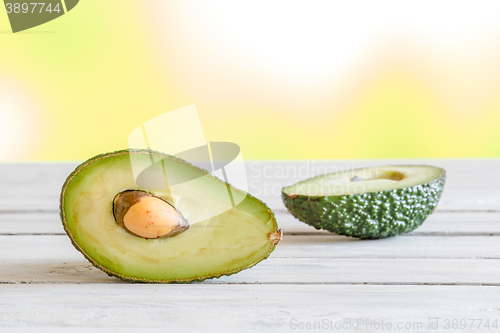 Image of Avocado in half on a table