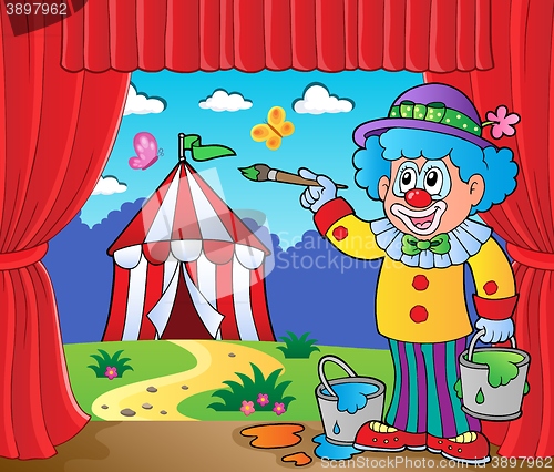 Image of Clown painting image of circus on stage