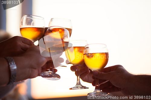 Image of Group of people toasting with white wine