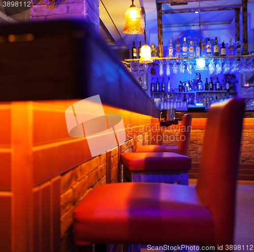 Image of Seats in a brightly lit cocktail bar or nightclub