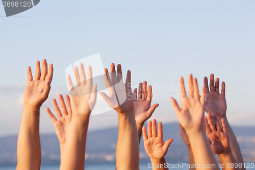 Image of Unrecognizable people pulling hands in the air