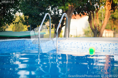 Image of Outdoor swimming pool with tiled blue walls