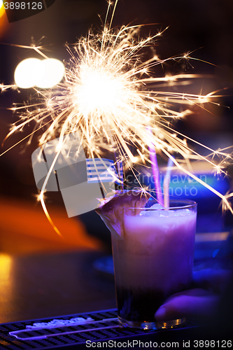 Image of Close-up of pina colada with Bengal light sparkling