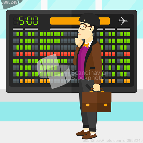 Image of Man looking at schedule board.