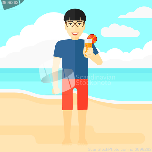 Image of Tourist with cocktail on the beach.