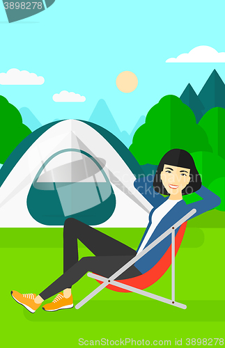 Image of Woman sitting in folding chair.