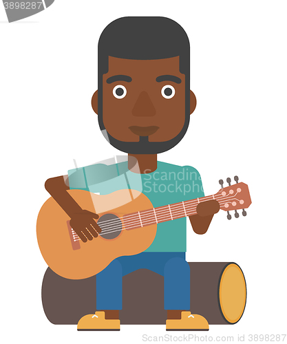 Image of Man playing guitar.