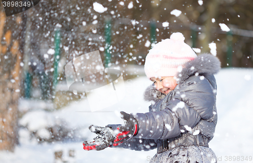 Image of Little girl is throwing snow